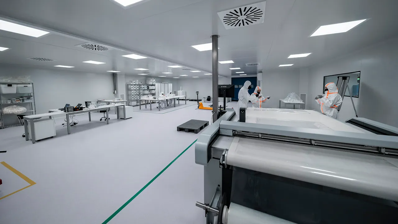 Gowned operator cleaning inside a controlled cleanroom environment